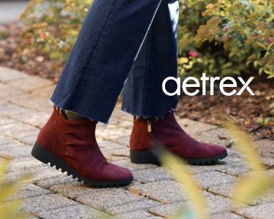Woman walking on pathway in Aetrex Zoey boots