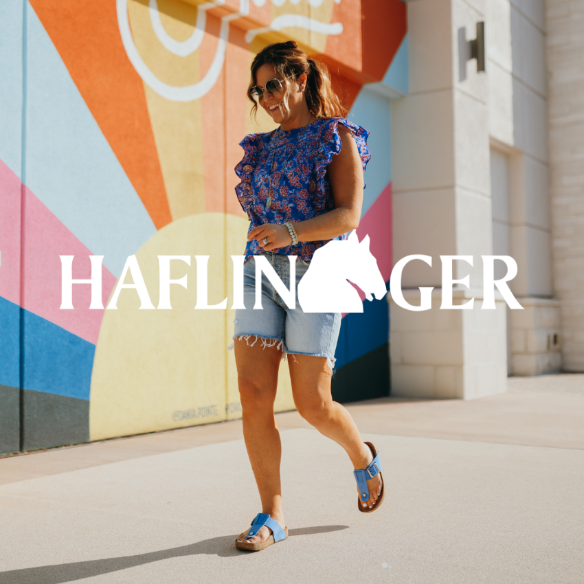 Woman walking past colorful mural