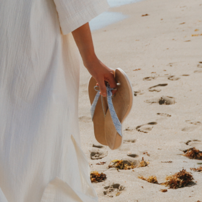 Woman holding shoes in hand