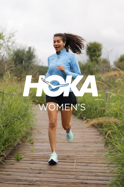 Woman running on pathway through park