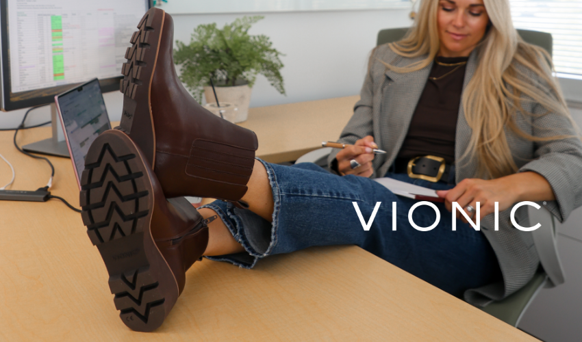 Woman sitting with feet up at desk in Vionic Aria boots