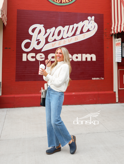 Woman standing in front of malt shop