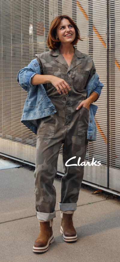 Woman standing on sidewalk wearing Clarks Hencroft boots