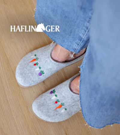 Woman standing on hardwood floors wearing Haflinger slippers