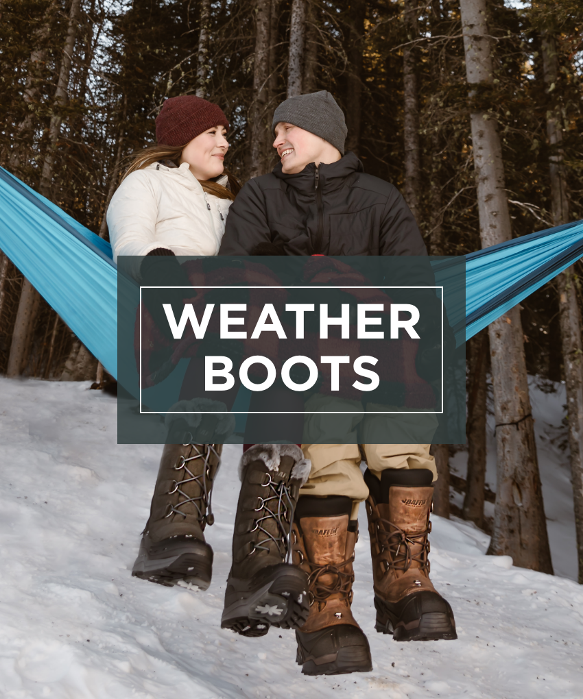 Man and woman sitting in hammock in tree wearing Baffin boot