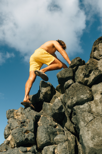 Man climbing up rocks