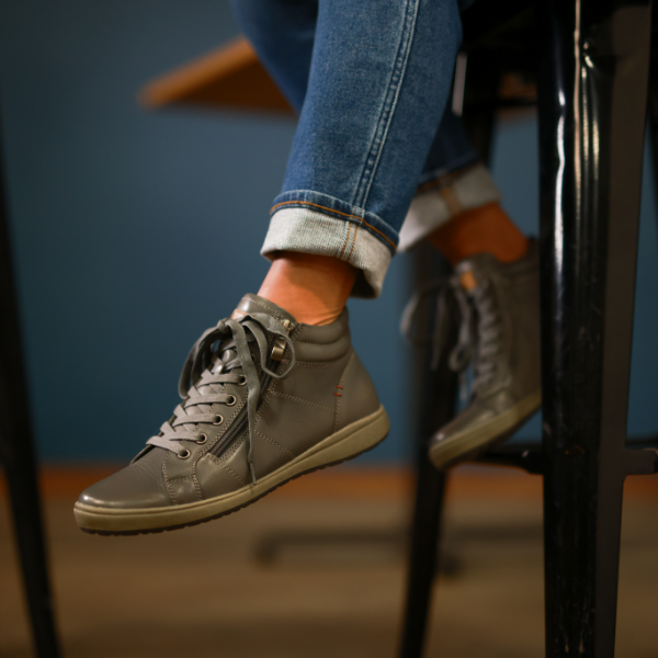 Woman resting feet on barstool
