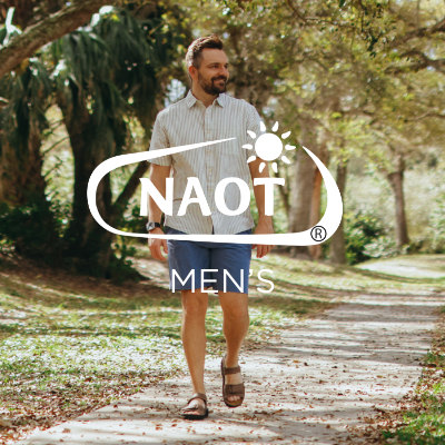 Man walking through wooded pathway