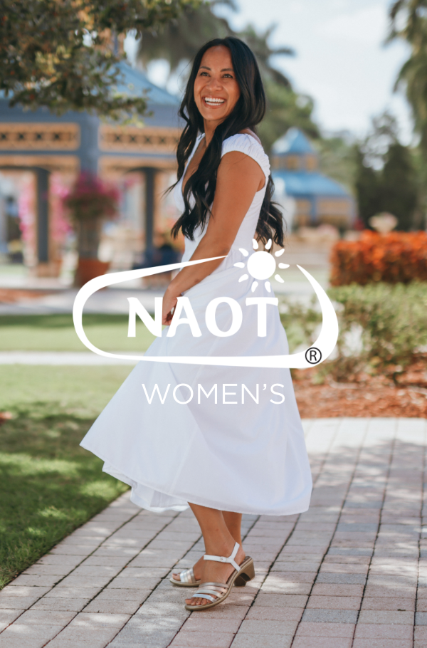 Woman standing on pathway swinging dress