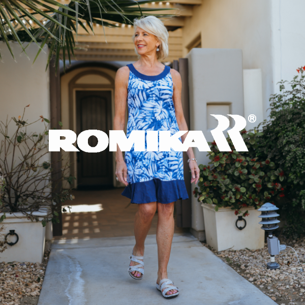Woman walking out of front door on pathway