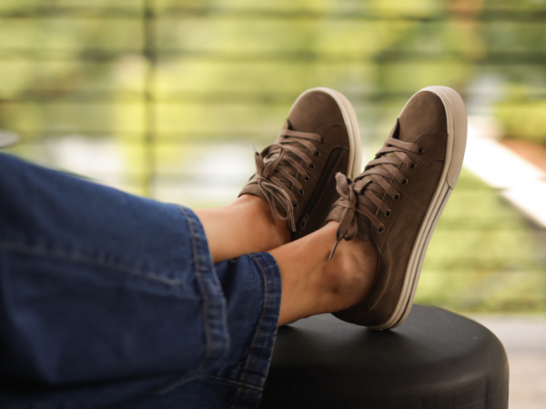 Woman resting feet on patio furniture