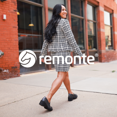 Woman walking down sidewalk looking back over shoulder