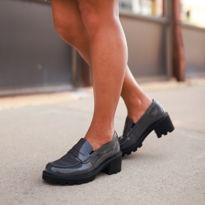 Woman standing on sidewalk