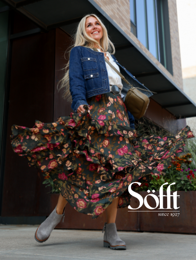 Woman twirling skirt around in Sofft Paige boots