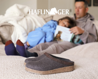 Dad reading daughter a book with Haflinger Grizzly Leather slippers on the floors