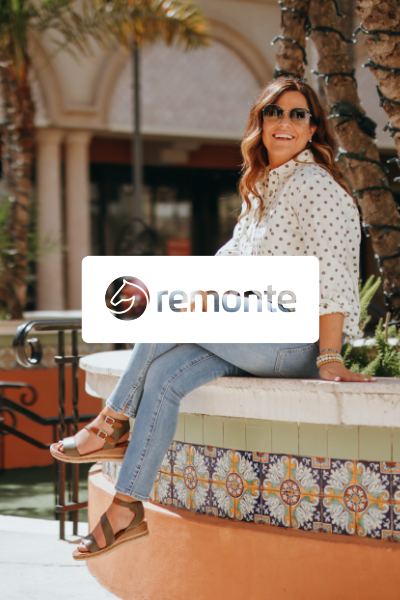 Woman sitting on ledge in shopping plaza