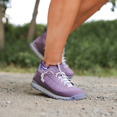 Woman walking on dirt road