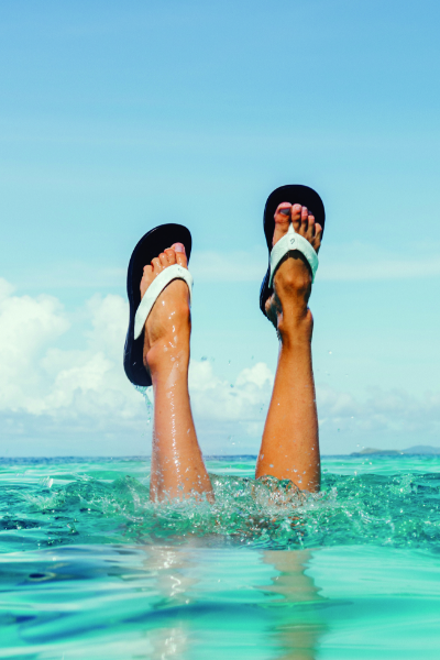 Woman underwater with feet above water
