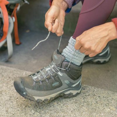 Woman lacing up boot