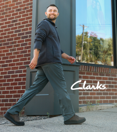 Man walking on downtown street in Clarks Mapstone Lo GTX shoes