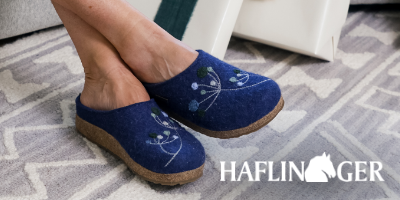 Woman sitting in chair wearing Haflinger Grizzly Amaya slippers