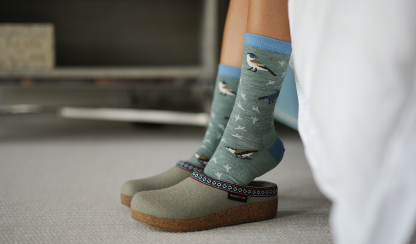 Woman stepping into slippers out of bed