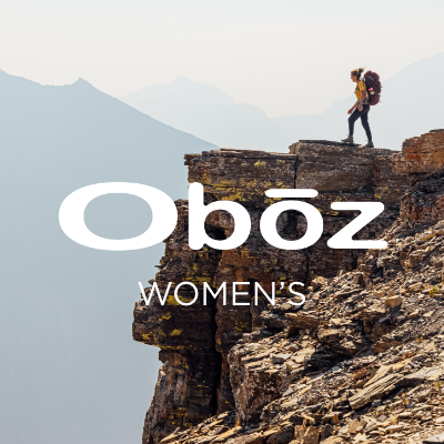Woman standing on ledge hiking
