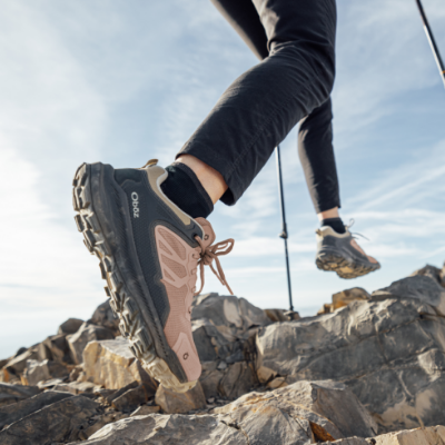 Woman hiking up rocky landscape