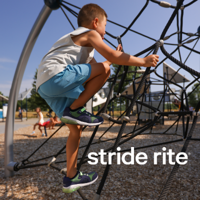 Kid crawling up obstacle on playground