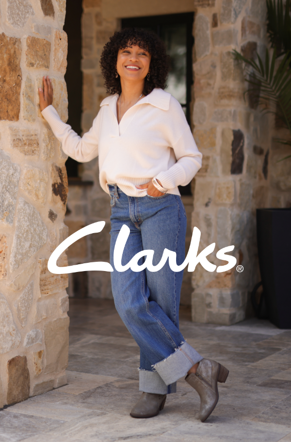 Woman leaning against stone wall