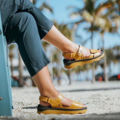 Woman sitting in chair at beach