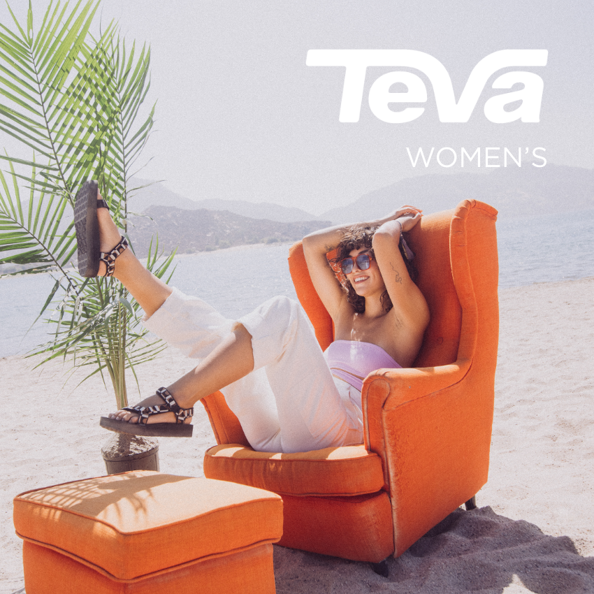 Woman sitting in chair with feet in the air