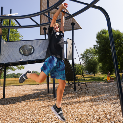 Kid climbing across monkey bars