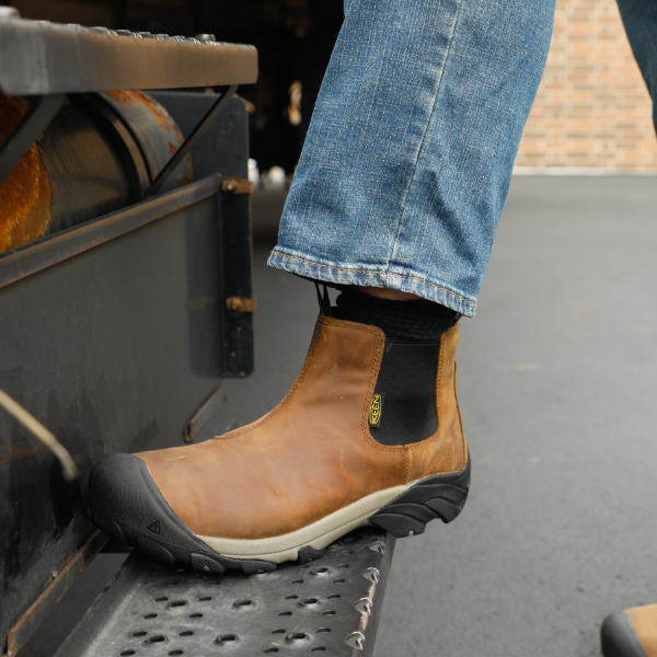 Man stepping up onto step of delivery truck 