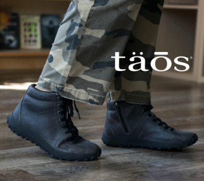 Woman wearing Taos boots in book store