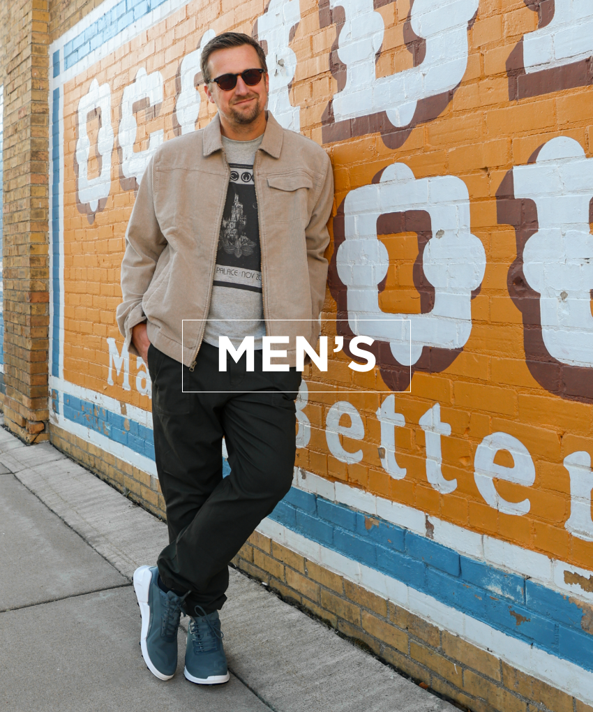 Man leaning against wall in Ecco sneakers