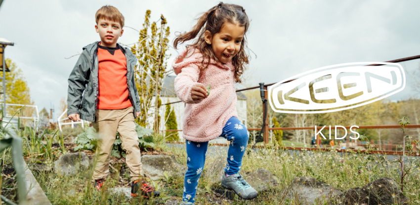 Boy and girl running through field