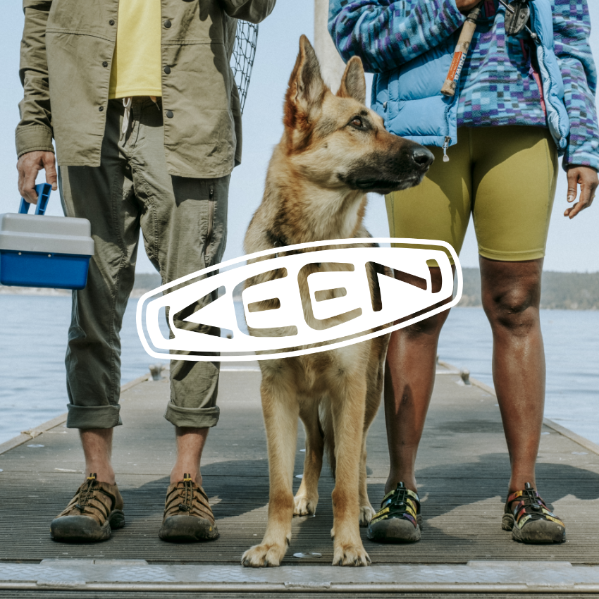 Man, Woman and dog standing on dock 