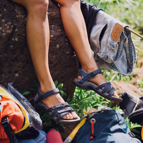 Woman sitting on stump at camp ground