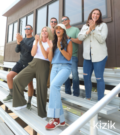 Parents cheering on kids in bleachers