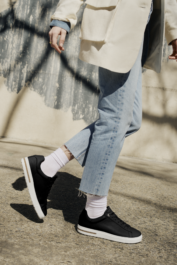 Woman walking on sidewalk