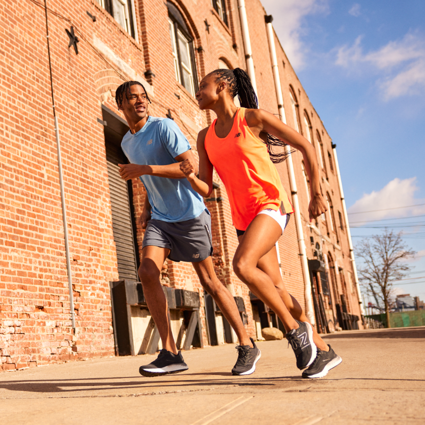 Man and woman running on sidewalk