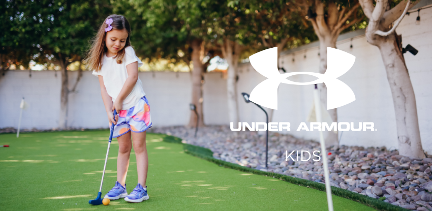 Kid playing on mini golf course