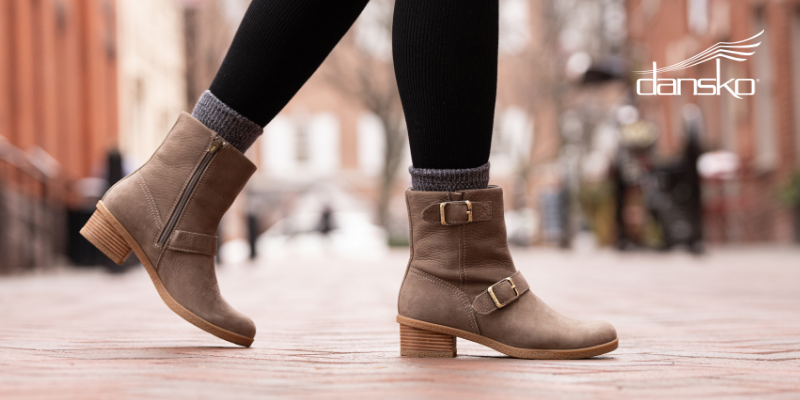 Woman walking in downtown area with Dansko Delphine boots