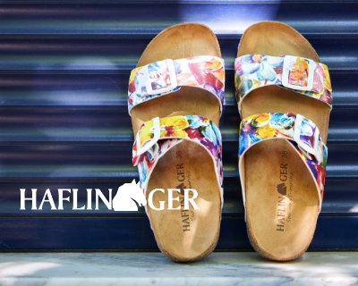 Haflinger sandals leaning against wall