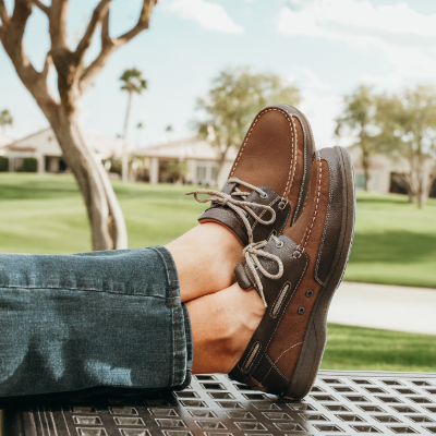 Man sitting with feet on outdoor table