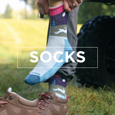 Woman pulling on Smartwool sock