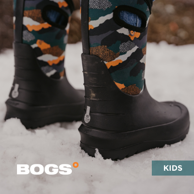 Kid standing in snow wearing Bogs boots