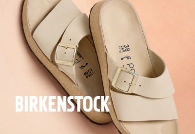 Birkenstock sandals laying on pink backdrop