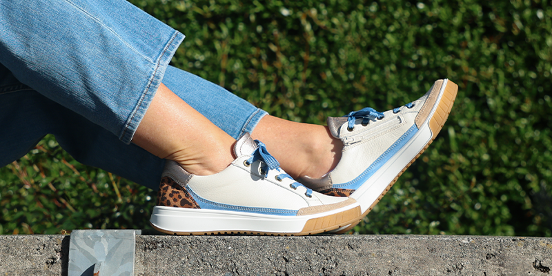 Woman in jeans wearing Ara Rio leopard print sneakers